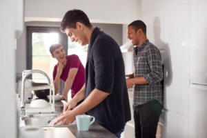 Students sharing dishwashing duties